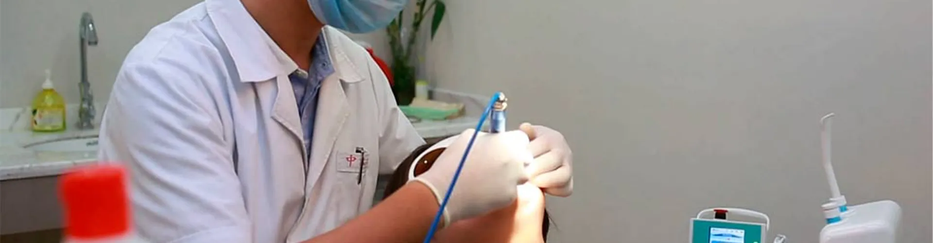 Dentist using laser treatment