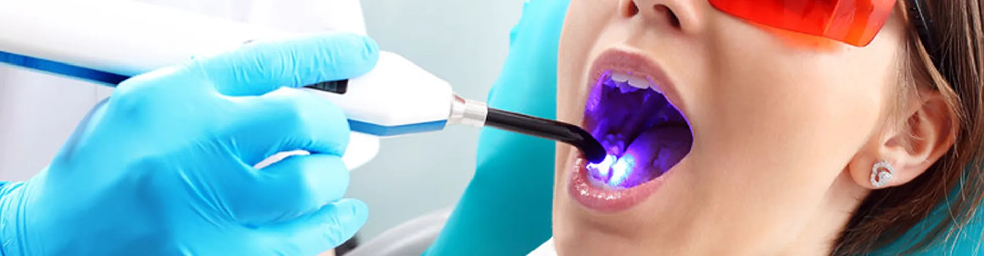 Dentist using laser treatment