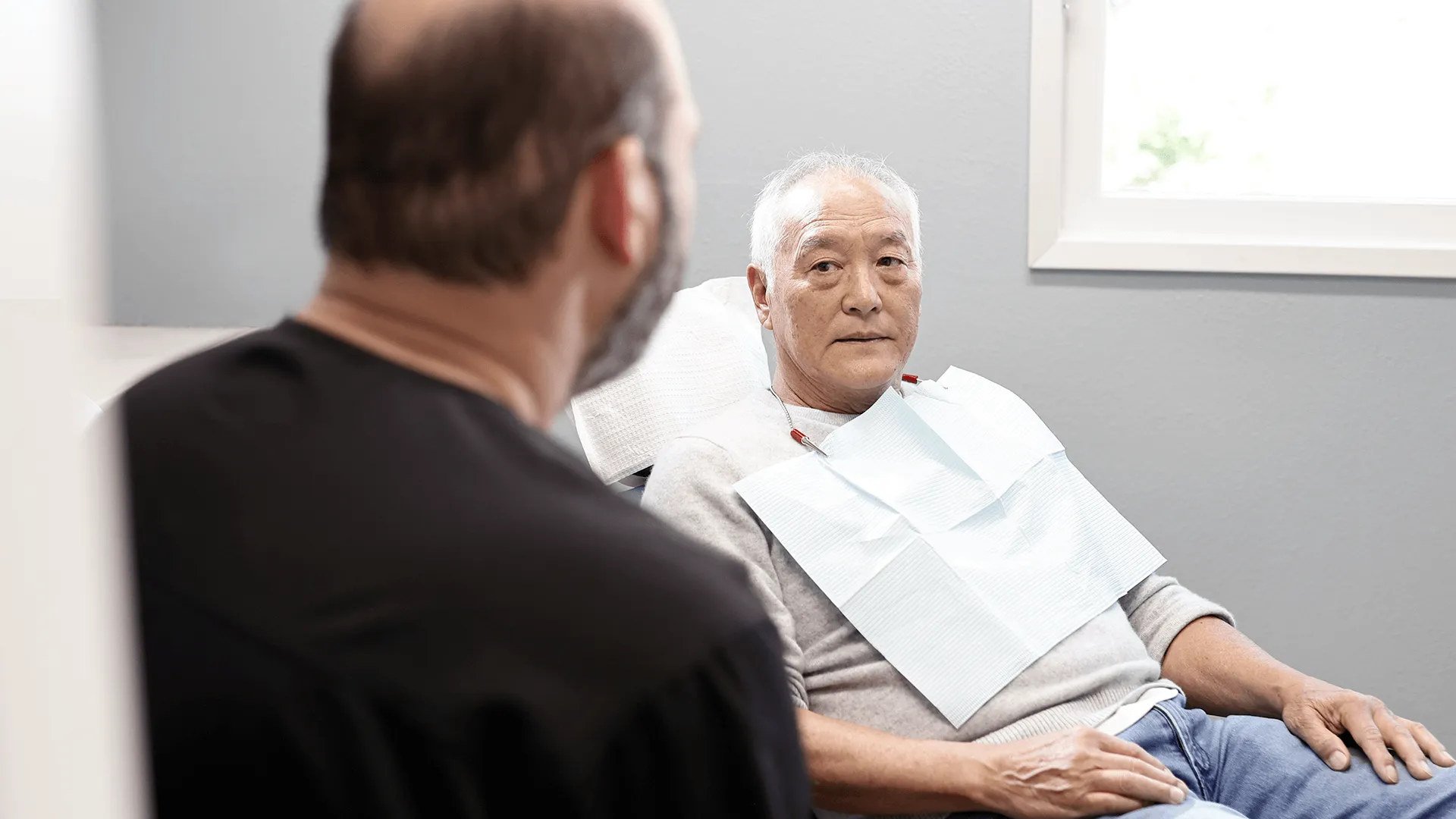 Dr. James Vartanian, smiling and in a relaxed demeanor, engaged in a consultation at Vartanian Dental Group.