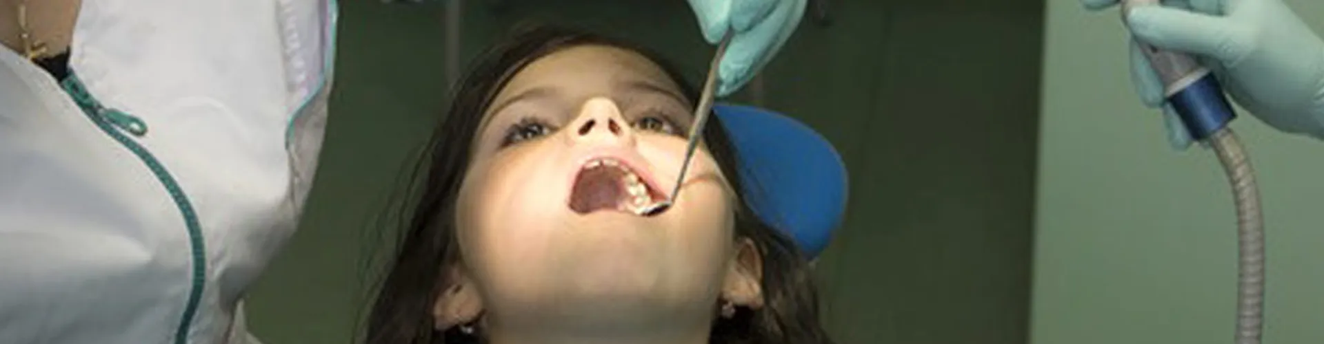 Girl being examined by dentist