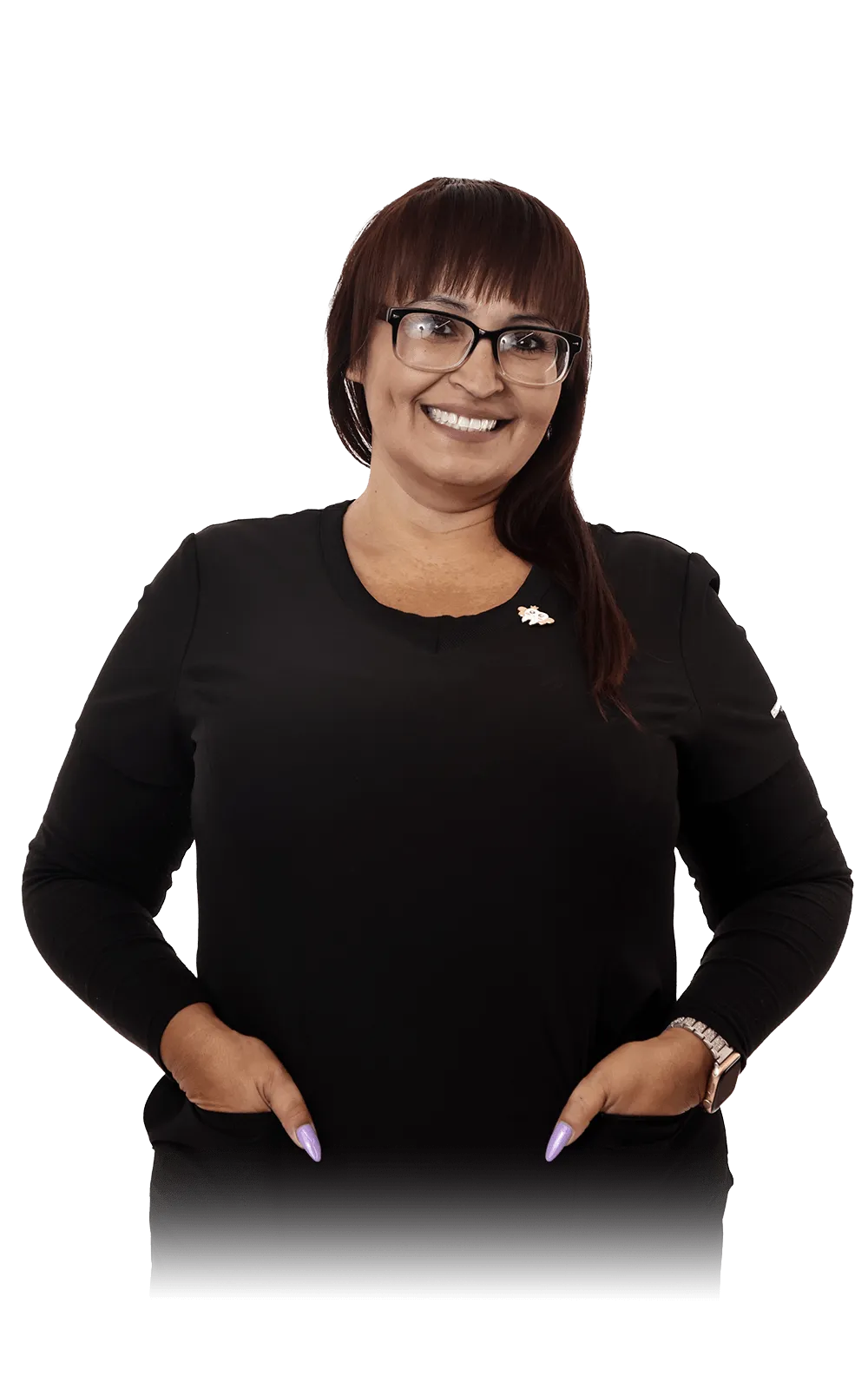 Portrait of Angelica Hernandez in a professional setting, wearing black scrubs with a pin on her top, and glasses. 