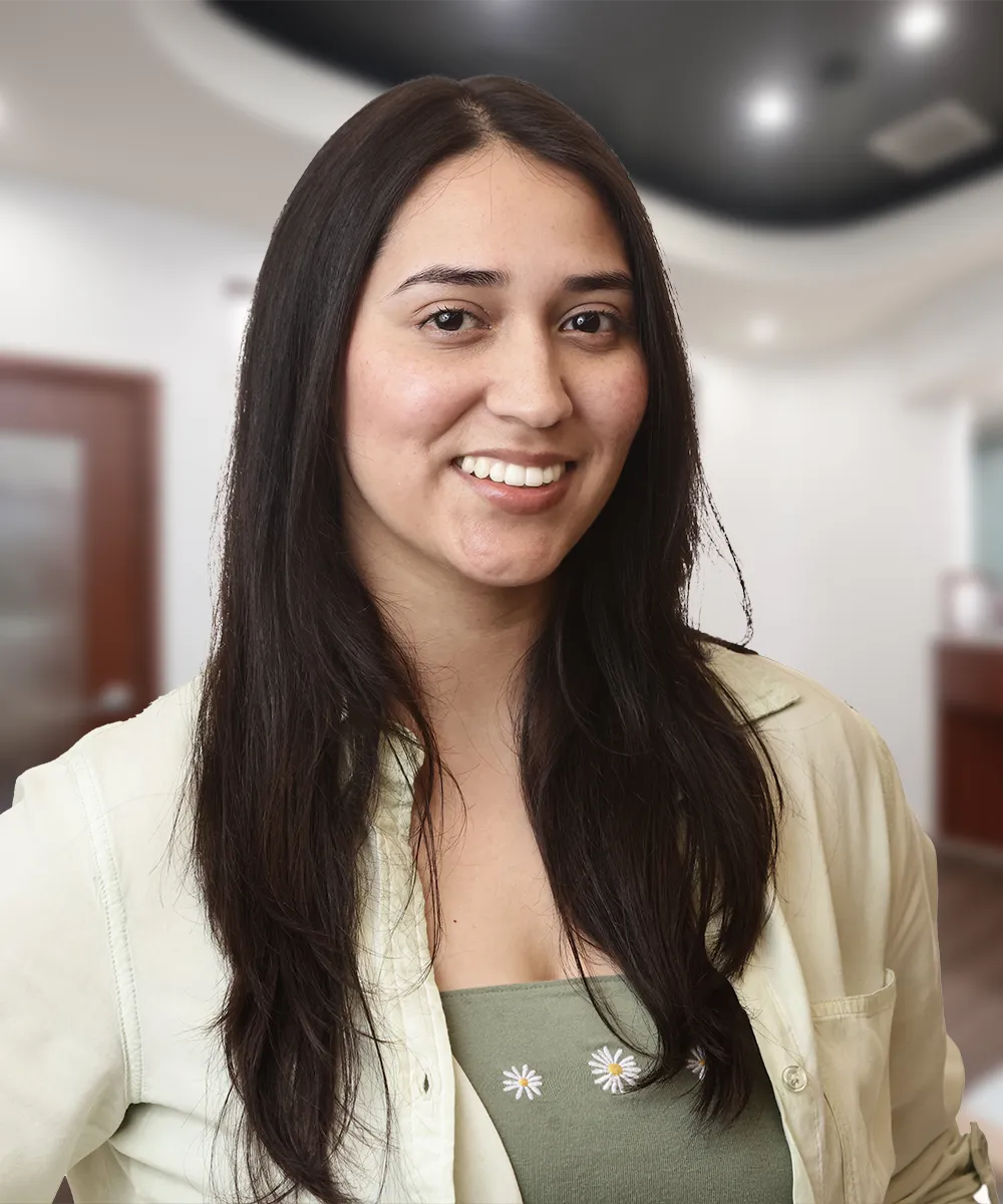 A headshot of Dulce M., smiling happily, symbolizing her satisfaction with the services of Vartanian Dental Group.