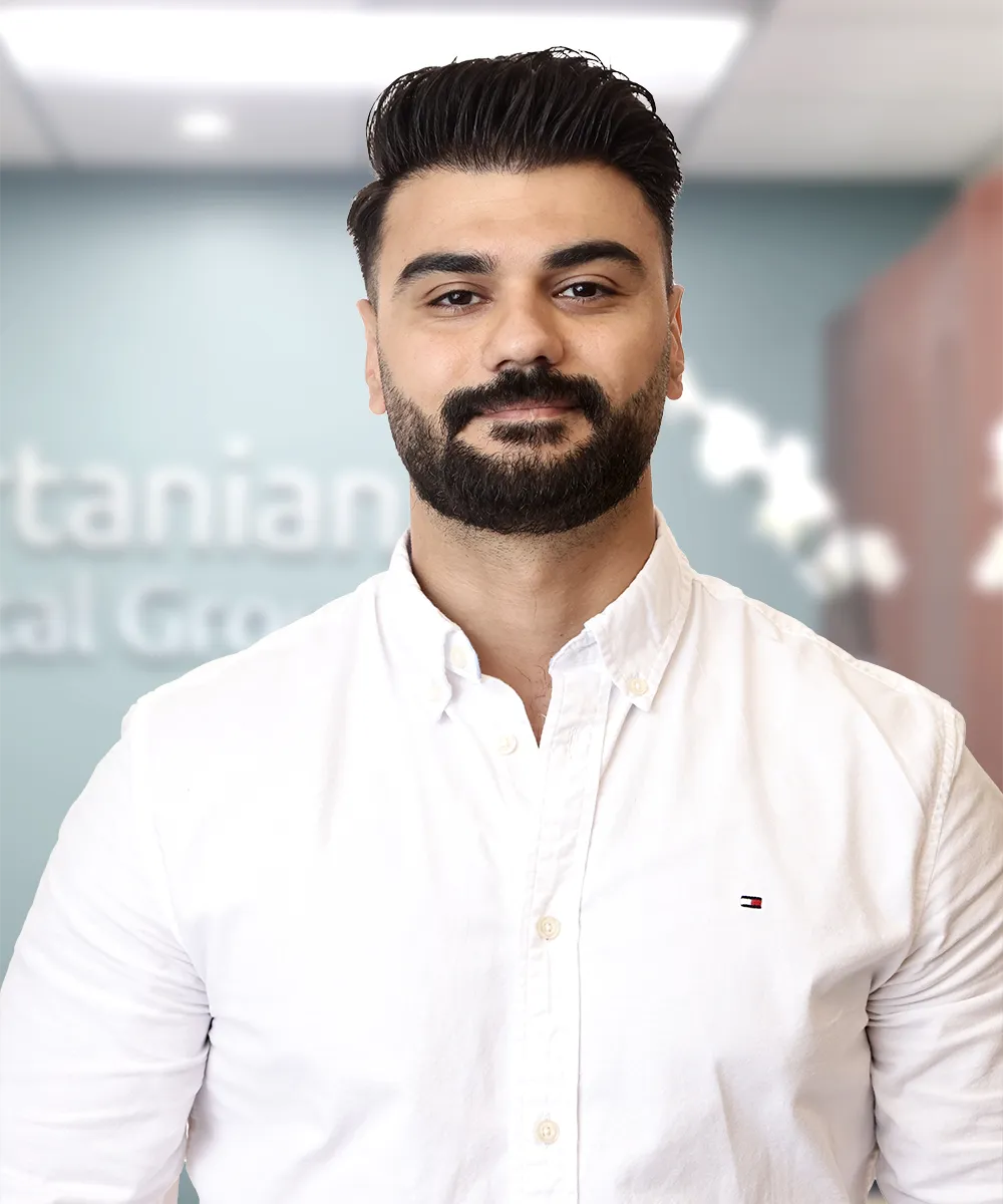 A portrait of Mohammad A., smiling with satisfaction, representing a happy patient’s testimonial for Vartanian Dental Group.